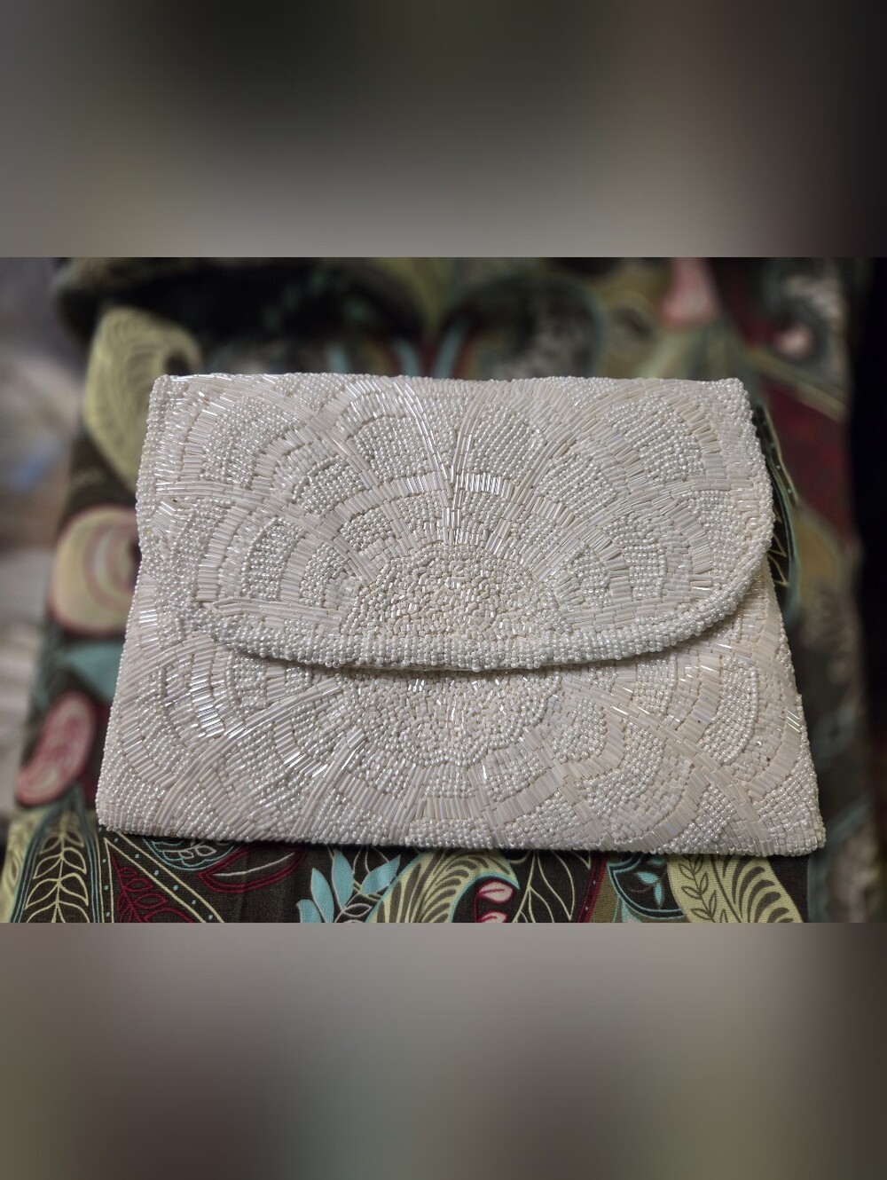 Elegant La Regale beaded envelope clutch w/ an intricate floral pattern + strap